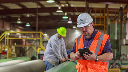 Inspector examining large pipe