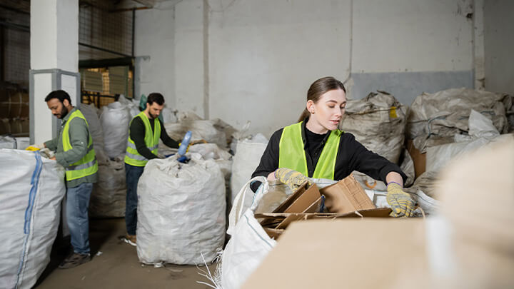 Small group of people sorting through recycling
