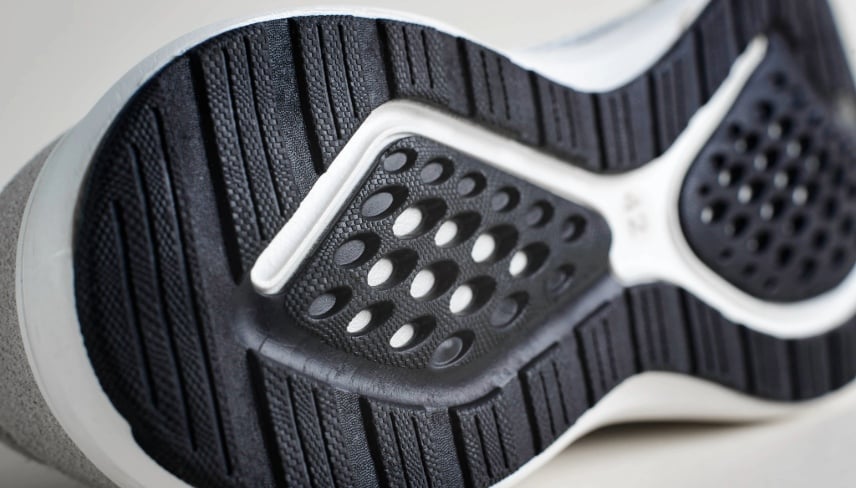 Close-up of a black textured sole of a shoe. 