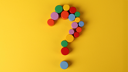 Game pieces forming a question mark on a yellow background.